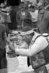 Native American man (Choctaw) in regalia sells medicine to crowd: Image 10 by Edwin E. Meek
