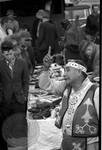 Native American man (Choctaw) in regalia sells medicine to crowd: Image 14 by Edwin E. Meek