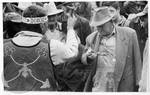 Native Amenrican man (Choctaw) in regalia sells medicine to crowd of men: Image 20 by Edwin E. Meek