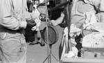 African American man buying fish from white man on street: Image 2 by Edwin E. Meek