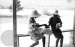 African American children sitting on porch railing by Edwin E. Meek