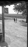 African American children walking away from store by Edwin E. Meek