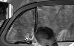 Child in car interior by Edwin E. Meek