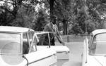 Cleve McDowell arrives on campus, exiting a car: Image 1 by Edwin E. Meek