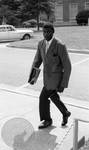 Cleve McDowell walking up stairs by Edwin E. Meek