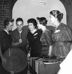 Group of unidentified students and record player by Edwin E. Meek