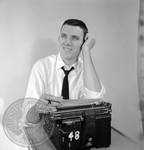 Bill Barton seated at typewriter: Image 2 by Edwin E. Meek