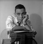 Paul Grey seated at typewriter: Image 2 by Edwin E. Meek