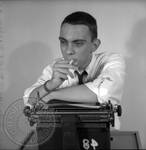 Paul Grey seated at typewriter: Image 3 by Edwin E. Meek
