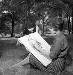 Pat McRaney drawing in park by Edwin E. Meek
