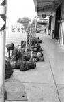 Troops resting on sidewalk at Oxford square by Edwin E. Meek