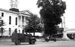 Military vehicles and troops in front of courthouse, Oxford Square: Image 1 by Edwin E. Meek