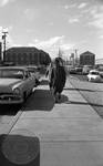 James Meredith walking down sidewalk by Edwin E. Meek