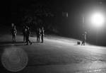 Military troops on campus at night: Image 1 by Edwin E. Meek