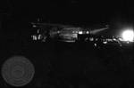 Military troops outside plane at night: Image 2 by Edwin E. Meek