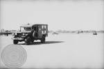 Military truck at airport by Edwin E. Meek