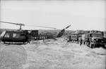 Military trucks and helicopter at off-campus encampment by Edwin E. Meek