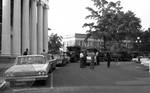 Police and military trucks outside Lyceum: Image 2 by Edwin E. Meek