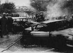 Military patrol with burned vehicles by Edwin E. Meek