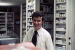 Unidentified pharmacist in pharmacy by Edwin E. Meek