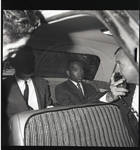 James Meredith being transported in car, accompanied by two United States Marshalls. by William T. Miles