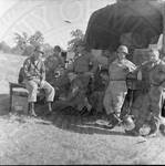 Eight National Guardsmen in front of an open supply truck. by William T. Miles