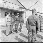 Four National Guardsmen standing at attention in front of the National Guard Armory. by William T. Miles