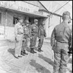 Four National Guardsmen standing at attention in front of the National Guard Armory. by William T. Miles