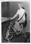 Woman on stationary bike, from See Tupelo magazine. by Author Unknown