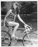 Model on bicycle, unidentified publication. by Author Unknown