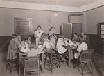 A class of underweight children being properly fed under the direction of the nutrition teacher, Franklin County, Alabama. 1927. by USDA Food and Nutrition Service