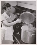 Mrs. Ruth McCeney, cafeteria manager, cooks soup for the children’s lunch, East Silver Spring Maryland Elementary School. by USDA
