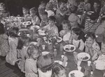 Twenty small children or 18 larger ones are served at a table. Children who bring their lunch from home may sit at the ends of the tables. Great variation is found in the rates at which the children eat, but the majority of them clean their plates (encouraged by principal and teachers.) by USDA