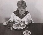 A school lunch - hearty and appetizing. Richard Sandstrom enjoys his milk before his school lunch - turkey and all the "fixings". NOTE: Meal includes sliced green beans, cranberry sauce, whole wheat bread with butter (or margarine), fruit cup, and milk. by USDA