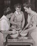 Hyattsville, Md., High School for work in the cafeteria. Here (left-right) Ann McNeil, Doris Brown, and Rose Donaldson mix the dough for biscuits to be served at noon to the 750 students fed daily under the joint Federal-State School Lunch Program. by USDA