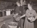 The principal of the rural school and farmwoman, who is the leading spirit in the school lunch project, check over the supplies that they have on hand. Rockbridge Co., Va. by USDA