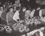 7th and 8th Grade students taking plates from serving counter. This school serves only a straight "A" lunch. School Lunch, Kirby Junior High School, Chicopee, Mass. by USDA