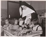 Through a cooperative agreement between the Federal Government and the State of Illinois, these children receive milk, free, at the Guardian Angel Nursery, 4500 McDonnell St., Chicago, Ill. Here Sister Humiliata pours the milk for her small charges. by USDA