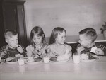 FUN, TOO Two sets of talkative twins eat noon lunches with reconstituted dry milk at Fairview School, Cullman County, Ala. In the middle are twins Jessie and Bessie Powell; Flanking them are Julen and Hulen Chambers. by USDA