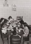 Schoolchildren in a large industrial city give thanks for the free school lunch prepared from surplus foods bought by the U.S. Department of Agriculture and turned over to local agencies for distribution to schools in low-income areas. by USDA