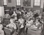 Schoolchildren eating lunch. Eva Mae Thompson in right foreground. Waynesville District School - Waynesville, Indiana by USDA