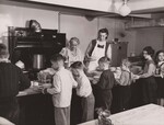 Youngsters go down the school-lunch line at the Center School in Bethel, Conn. Mrs. Edward Gordon, left, the cook, and Mrs. Fred L. Shepherd, an assistant, make sure the plates are full. NSL Program. by USDA