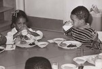 Children at a Baltimore day care center are shown topping off lunch with milk. Food assistance for this and other centers is provided by the U.S. Department of Agriculture's Food and Nutrition Service. Baltimore, Maryland. SCHOOLS - Pre Schools United States Department of Agriculture Office on Information by USDA