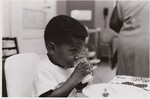 Youngster drinking milk at the Zellwood Center, Orlando, FL. by USDA