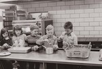 "Kindle their interest" - that's the secret, says one food service director in working with young children to interest them in a nutrition education project. This group of children from Metz Elementary School in Westminster, Colorado, April 1972, have made tacos a part of the food education program to learn nutrition. Westminster, Colorado. SCHOOLS United States Department of Agriculture Office on Information by USDA