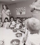 SCHOOL BREAKFAST Children at Woodburn Child Care Clinic are shown saying grace before eating breakfast. This center for children of migrant farm workers is partially sponsored by USDA's Food and Nutrition Service programs, which administers several food service programs to aid centers such as this in providing healthful, nutritious meals. Woodburn, Oregon, August 1972. by USDA