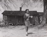 Mary Elizabeth Artis leaves her home here for school March 9, 1965. On this day, she did not carry a lunch to school nor did she have money to buy a lunch at school. Her school does not participate in the National School Lunch Program administered by the U.S. Department of Agriculture's Consumer and Marketing Service. Macclesfield, North Carolina.
