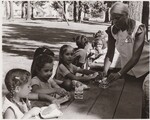 SCHOOL LUNCH - Summer Feeding United States Department of Agriculture Office of Communication Alberta Park is one of some [75] summer Feeding Program sites in Portland, Oregon. About 40 children eat lunch at the park daily. Here lunch is distributed to eager youngsters by park attendant August 1972. The program started May 30, 1972 feeding 1200 youngsters a day. And their peak 7000 meals were being packed daily. The Summer Feeding Program ended August 11, 1972. This program is sponsored by U.S. Department of Agriculture's Food and Nutrition Service. by USDA