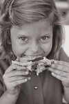 Child eating chicken in School Lunch Program. June 16, 1970. by USDA