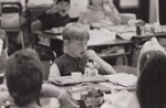Young school children eating their lunch at their desk in the classroom. by USDA